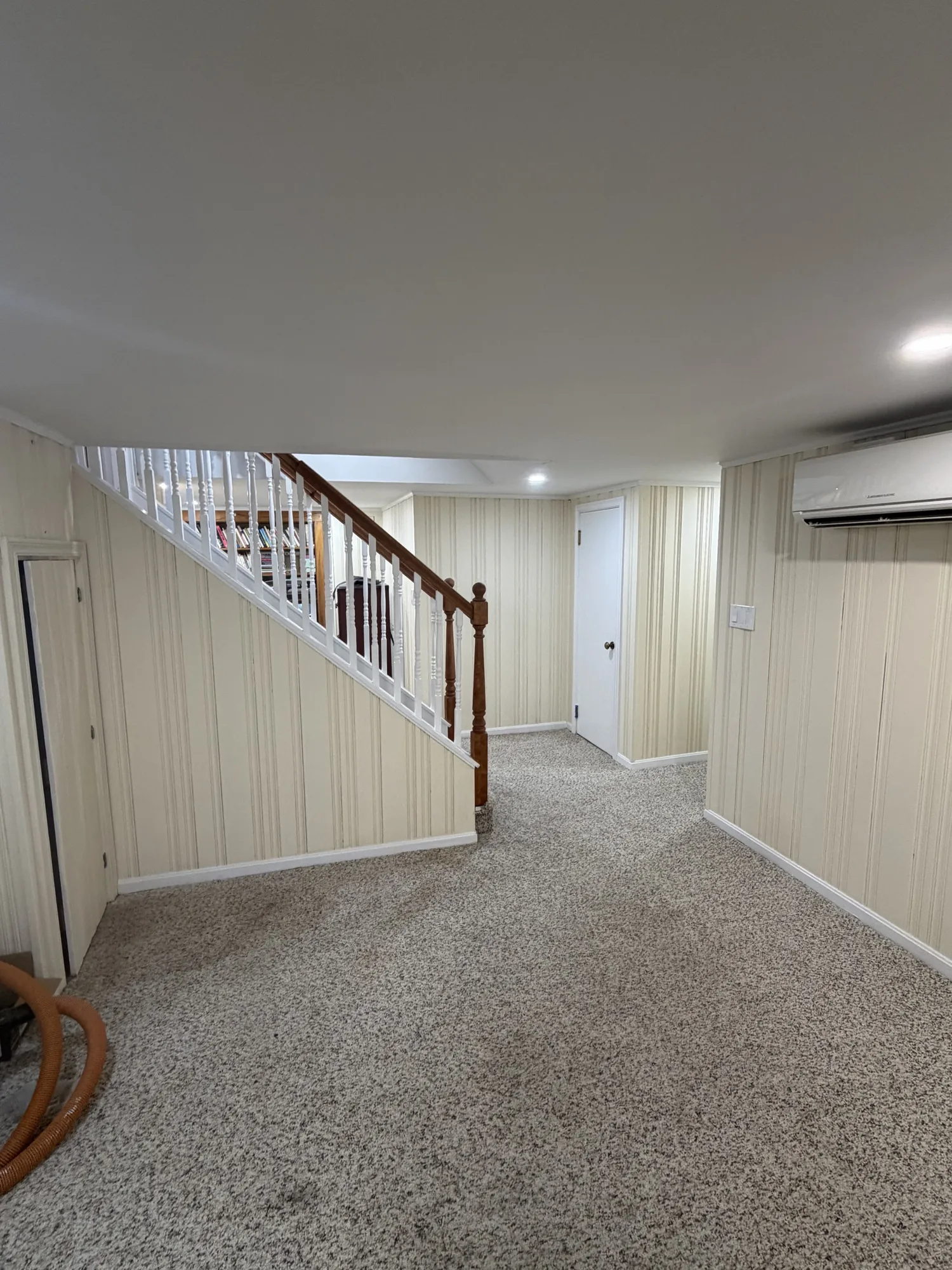Finished basement family room with staircase