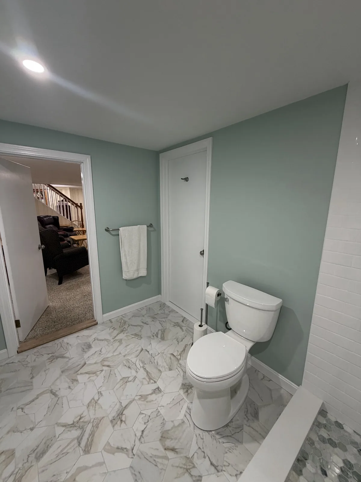 Finished basement bathroom with marble tile